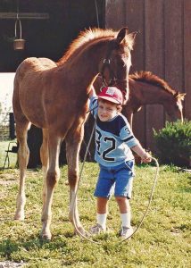 Young Trevor with a horse